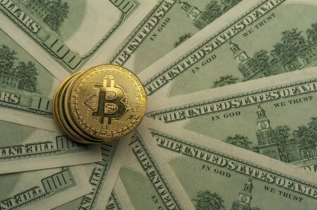 Close-up of golden Bitcoin coins lies on piles