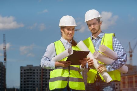 Portrait of Woman And The Man Are The Chief Engineers Of The Project In Green Vests