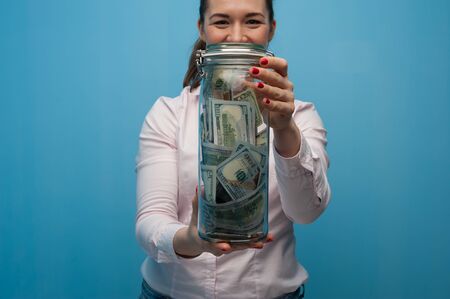 Young charming woman holds a jarの写真素材