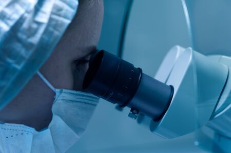 Female lab technician in a protective maskの写真素材