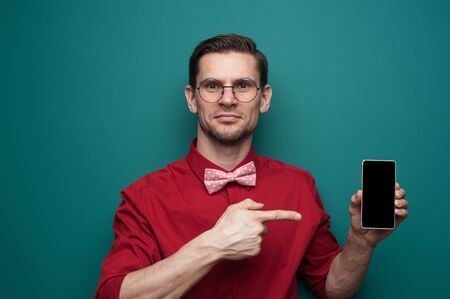 Portrait of positive young male hipster looking at cameraの写真素材