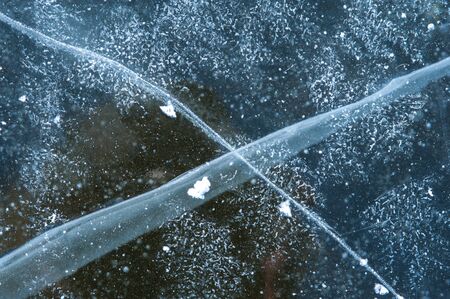Close-up of a cross-shaped crack on the iceの写真素材