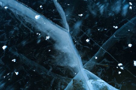Top view white flakes of snow lie on the iceの写真素材