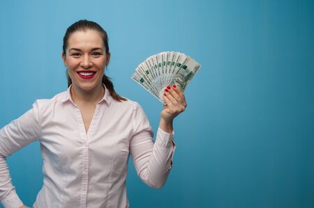 Happy young emotional caucasian woman with rublesの写真素材
