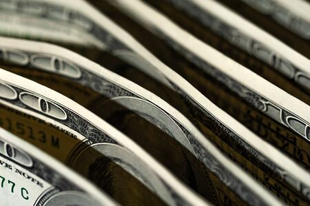 Paper dollar bills are standing next to each otherの写真素材