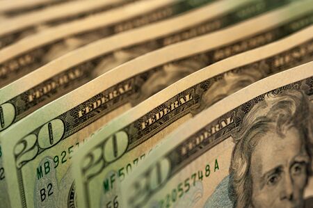 Paper dollar bills are standing next to each otherの写真素材