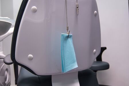 Blue napkin is attached to a chain on the chairの写真素材