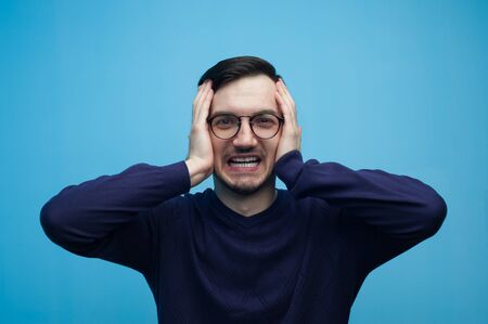 Portrait of an emotional young man in glassesの写真素材