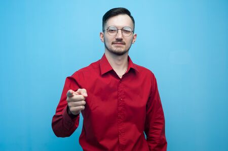 Young positive man in glasses and a red shirtの写真素材