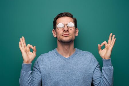 Portrait of a positive young man in glassesの写真素材