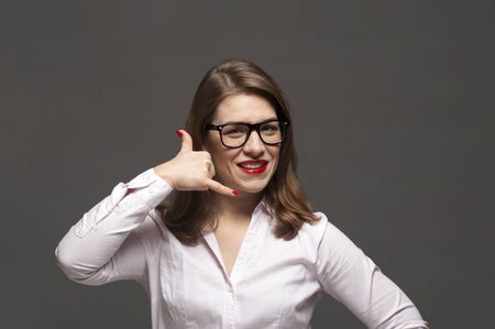 Close-up portrait of young woman with eyeglasses and red lipsの写真素材