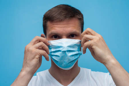 Portrait of man wearing an anti virus protection mask to prevent corona virus.の写真素材