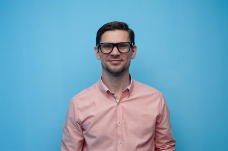 Close-up portrait of a handsome positive young manの写真素材
