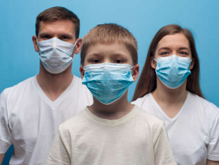 Parents and child son wearing protective medical mask.の写真素材