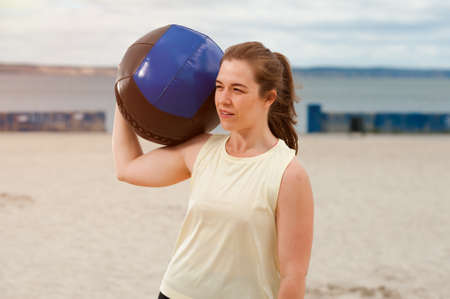 Portrait of positive woman with medicine ballの写真素材