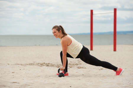 Fit woman during kettlebell training.の写真素材