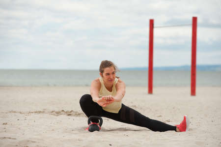 Portrait of positive woman wearing top and leggings warming up.の写真素材