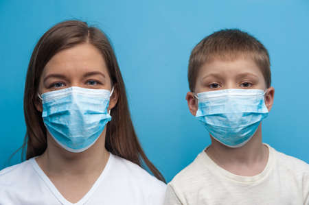 Caucasian mother and son wearing protective medical mask.の写真素材