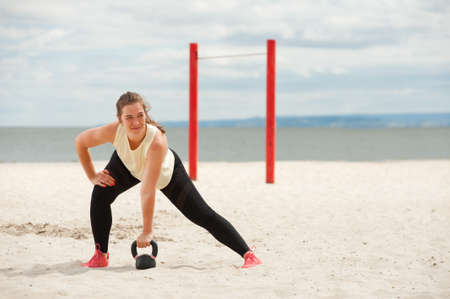 Portrait of positive woman wearing top and leggings warming up.の写真素材