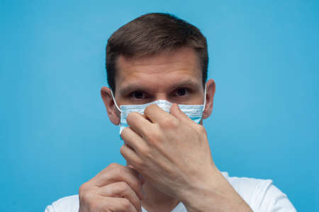 Portrait of man wearing an anti virus protection mask to prevent corona virus.の写真素材