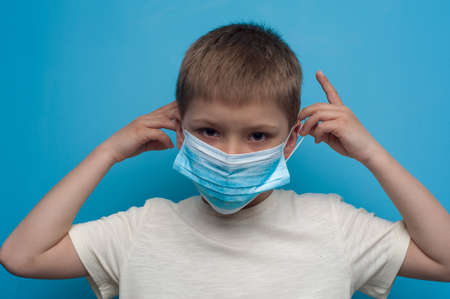 Portrait of child wearing an anti virus protection mask to prevent corona virus.の写真素材