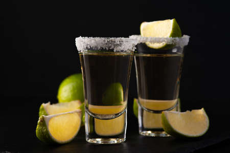 Mexican Gold Tequila with lime slices and salt.の写真素材