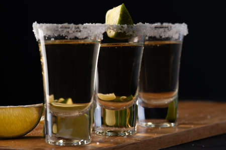 Mexican Gold Tequila with lime slices and salt.の写真素材