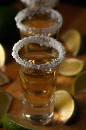 Mexican Tequila Gold in glasses with lime slices and salt.の写真素材