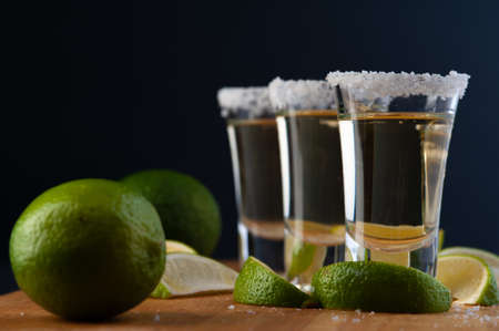 Mexican Gold Tequila with lime slices and salt.の写真素材