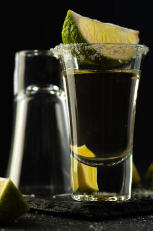 Mexican Tequila Gold in glasses with lime slices and salt.の写真素材