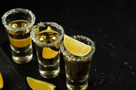 Mexican Gold Tequila with lime slices and salt, top viewの写真素材