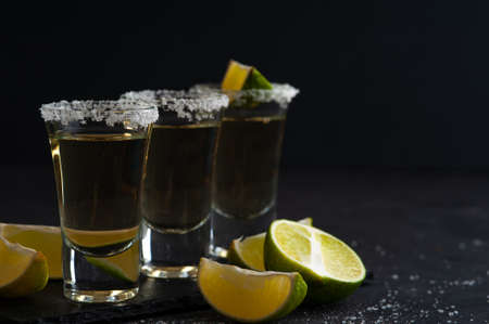 Mexican Gold Tequila with lime slices and salt.の写真素材