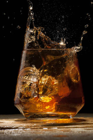 Close-up ice cubes falling into a glassの写真素材