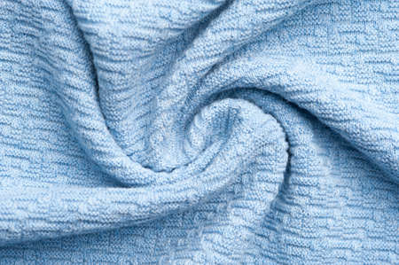 Close-up fragment of warm knitted blue sweatshirts. Concept of warm everyday things. clothing store concept. Advertising space. Place for textの写真素材