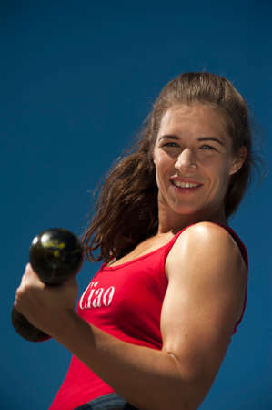 Portrait of Fitness Female Wearing Red Swimsuit Exercising With Vintage Dumbbellの写真素材