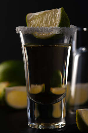 Gold Mexican Tequila shot with lime slice and salt.の写真素材