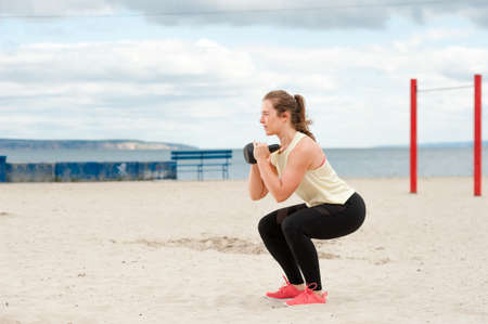 Athletic young woman during beach workout.の写真素材