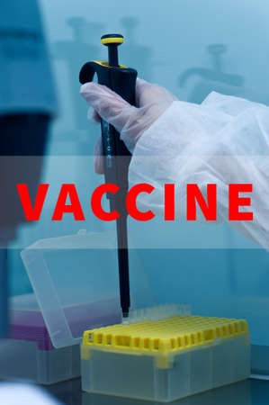 Closeup of microbiologists hand opening test tube with  vaccineの写真素材