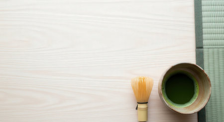 Japanese matcha green tea with bamboo mat and whisk on wooden table backgroundの素材