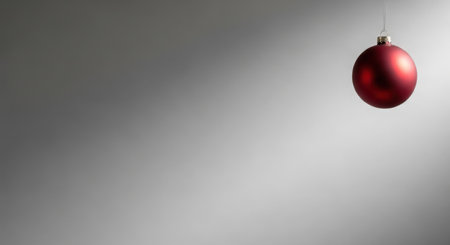 Red christmas ball on gray background with copy space for your textの素材