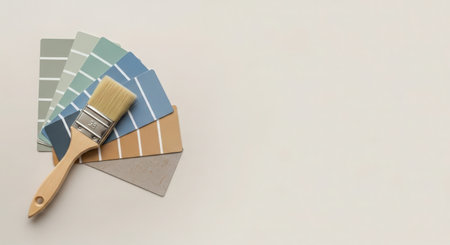 Paint brushes and color swatches on white background with copy spaceの素材