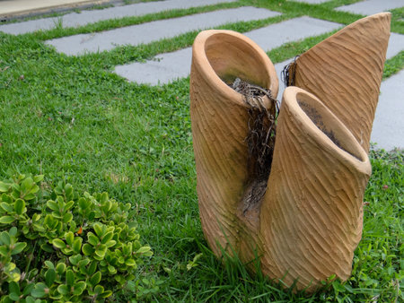 Clay pots on the green grass in the gardenの写真素材