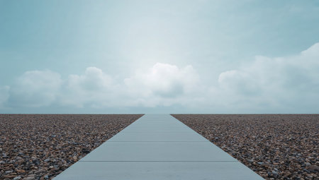 Concrete pathway on the beach with blue sky and cloud background.の素材
