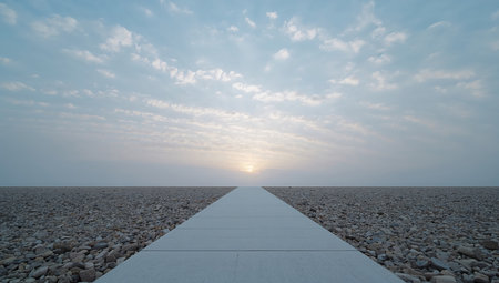 Pebble walkway leading to the sun at sunset in summerの素材