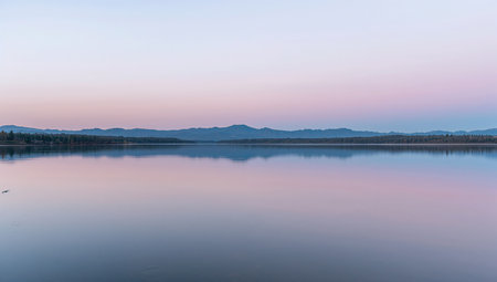 Sunrise on the lake with mountains in the background and blue skyの素材