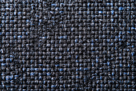 A detailed close up of a dark, woven fabric. Blue threads are interspersed throughout, adding subtle color. The texture is rough and the weave is tight, creating a unique pattern. Perfect for backgrounds.の素材