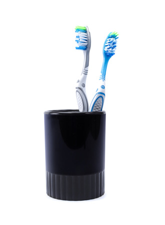 Two toothbrushes in a glass isolated on white backgroundの写真素材