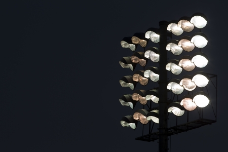 Stadium lights against dark night sky backgroundの写真素材
