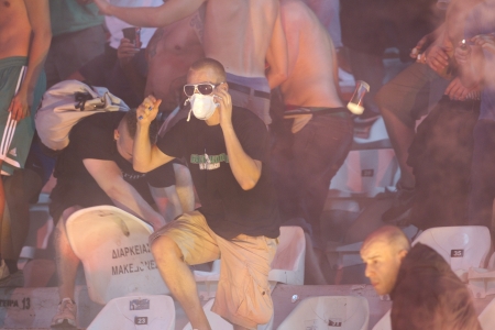 THESSALONIKI, GREECE-AUG 23,2012:Clashes PAOK Thessaloniki and Rapid Vienna fans and the police before UEFA Europe League Playoff Football Match at Toumba Stadium のeditorial素材