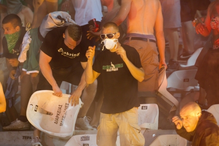 THESSALONIKI, GREECE-AUG 23, 2012:Clashes PAOK Thessaloniki and Rapid Vienna fans and the police before UEFA Europe League Playoff Football Match at Toumba Stadium のeditorial素材